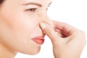 Woman pinching nose
